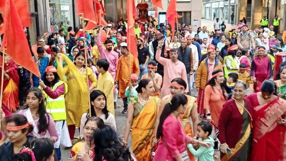 A group of people dressed in colourful clothing at the celebration