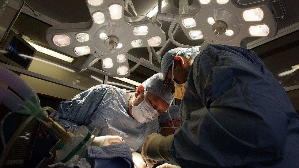 Surgeons perform a kidney transplant