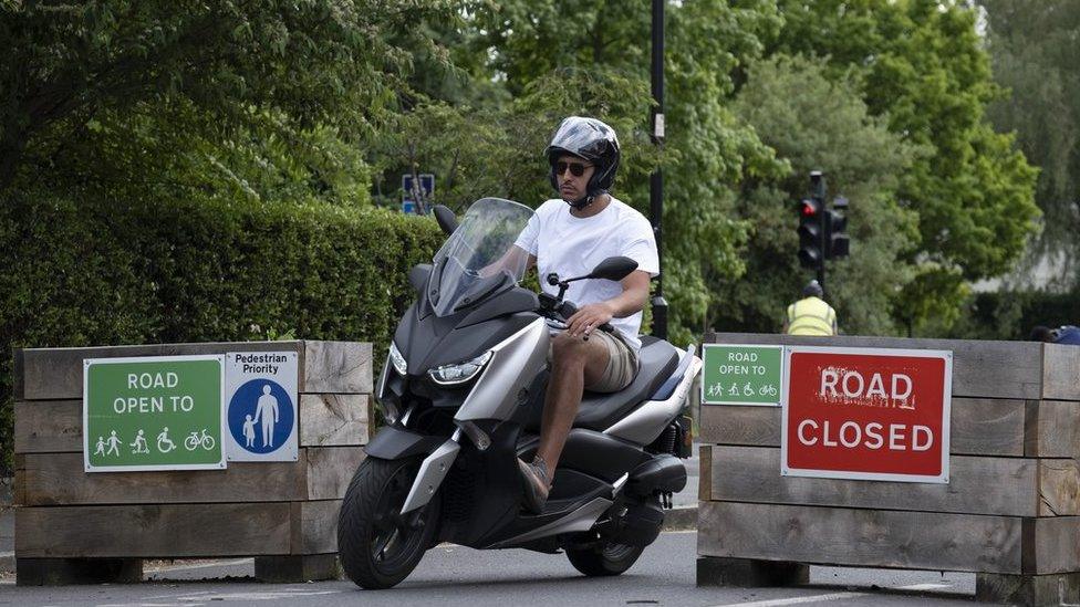 Motorcyclist and an LTN sign