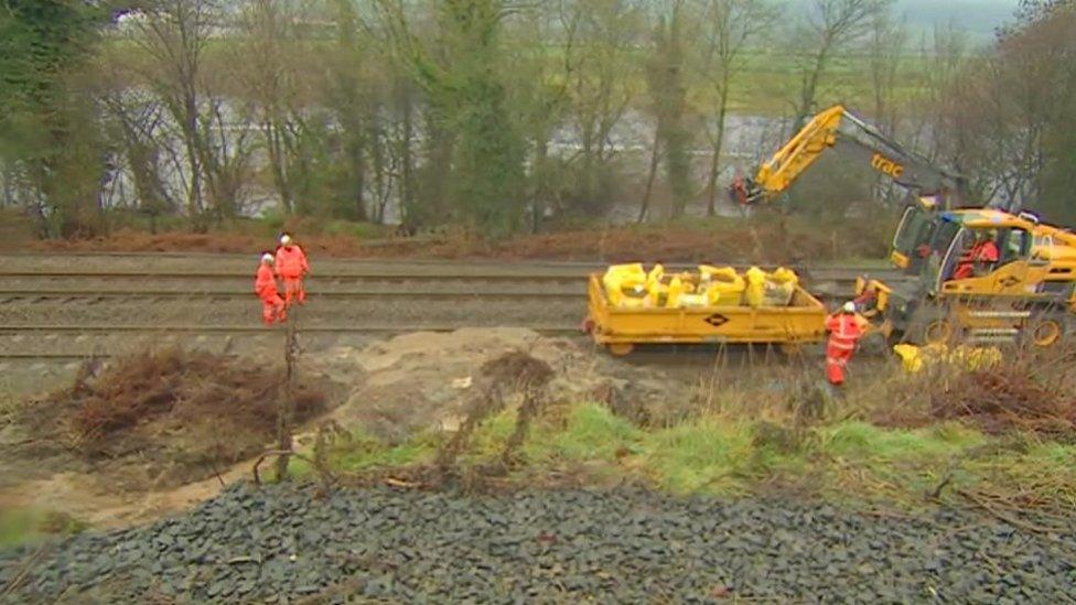 Engineers work to clear the landslide from the rail line near Hexham