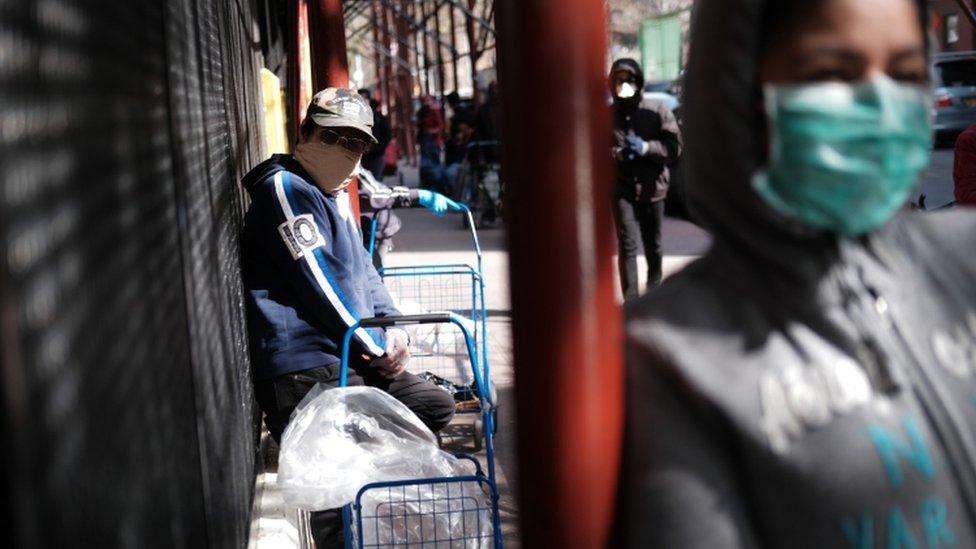 People queue at a food distribution centre in Harlem, New York