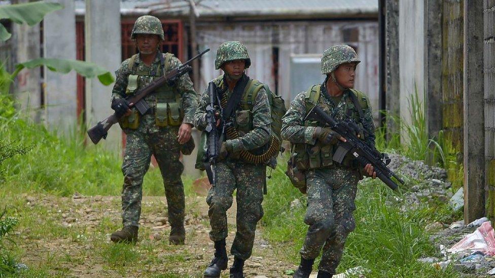 Philippine marines patrol a deserted area on their way to assault an Islamist militants' hideout in Marawi