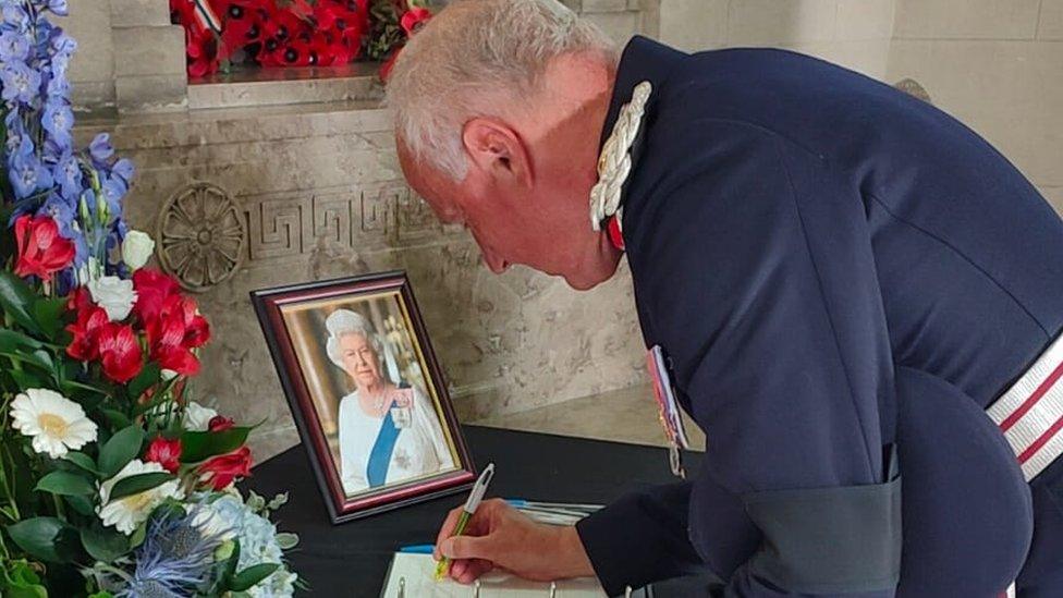 Lord Lieutenant of the West Midlands John Crabtree signs a book of condolence