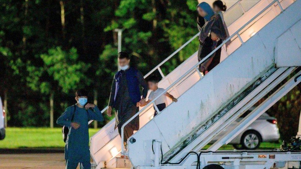 British nationals and Afghan evacuees depart a flight from Afghanistan at RAF Brize Norton