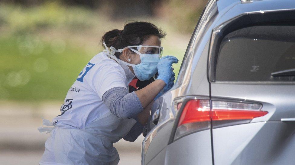 Tests being carried out at a coronavirus testing site in a car park in London