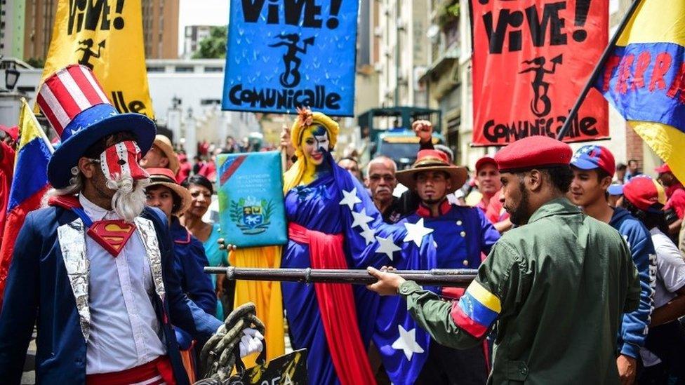 Pro-government activists representing a Venezuelan Bolivarian revolutionary (R) and Uncle Sam (L) perform during a demonstration to support President Nicolas Maduro, in Caracas, on August 14, 2017.