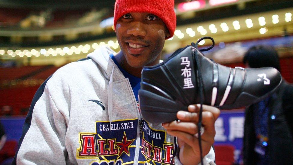 Stephon Marbury shows off the shoe he is promoting prior to the Chinese Basketball Association All-Star Game in Beijing