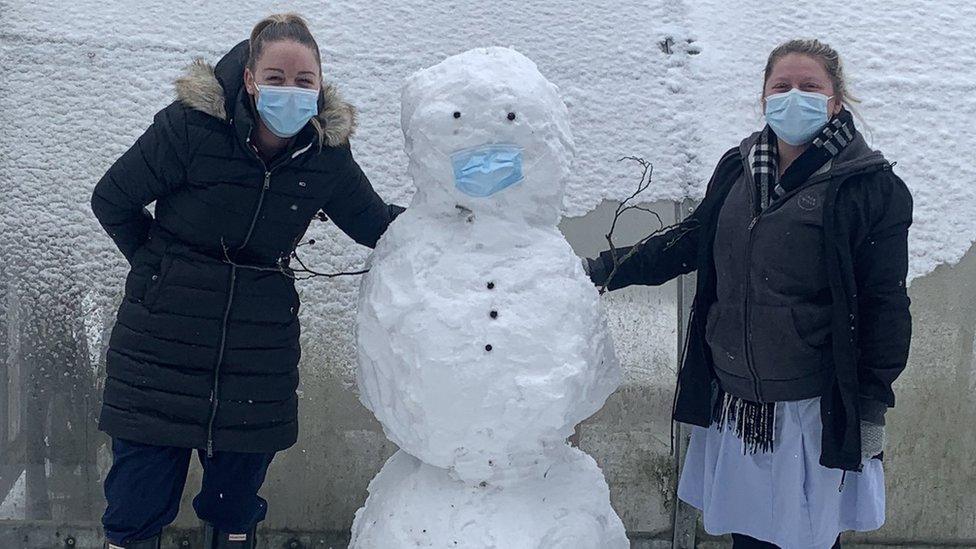 NHS staff members Danielle Howlett and Nikki Brooks with a snowman