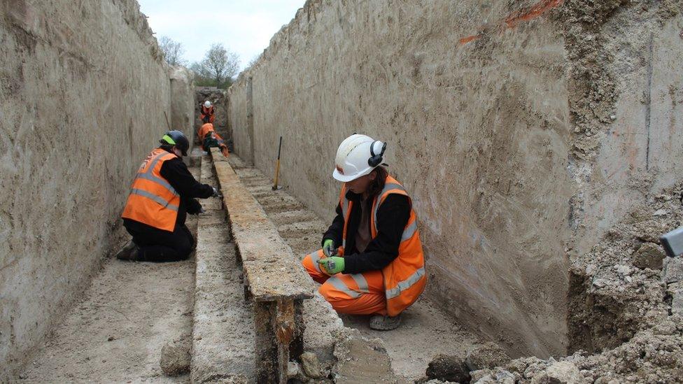 Archaeologists excavating one of the catapult's arms