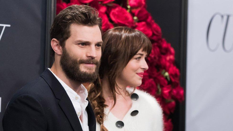 Jamie Dornan, left, and Dakota Johnson attend a special fan screening of Fifty Shades of Grey