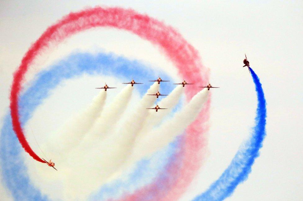 Red Arrows performing at the Sunderland International Airshow with coloured smoke in the sky