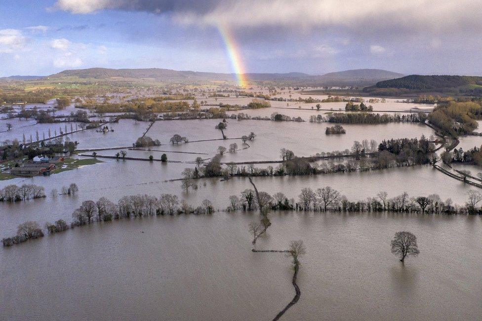 A rainbow appears over flooded fields in the Wye Valley, near the hamlet of Wellesley.