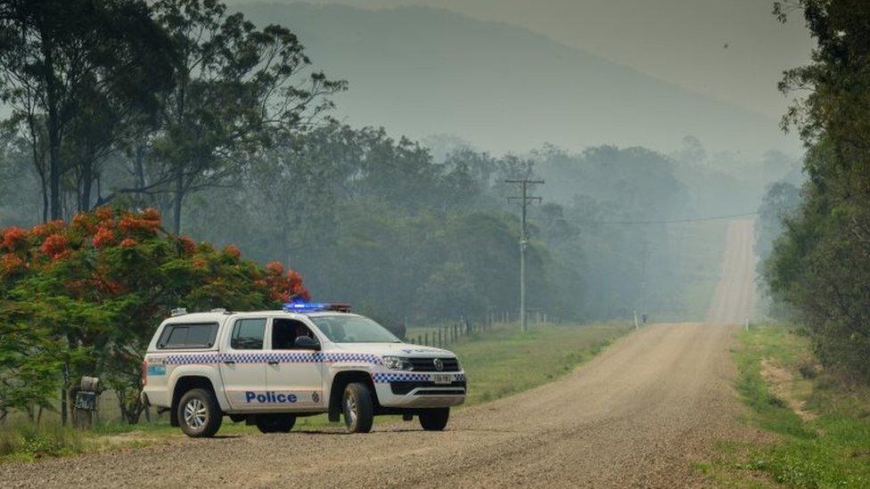 Police block off road to check houses in area affected