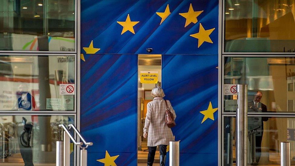 A woman walking into the European Commission building in Brussels