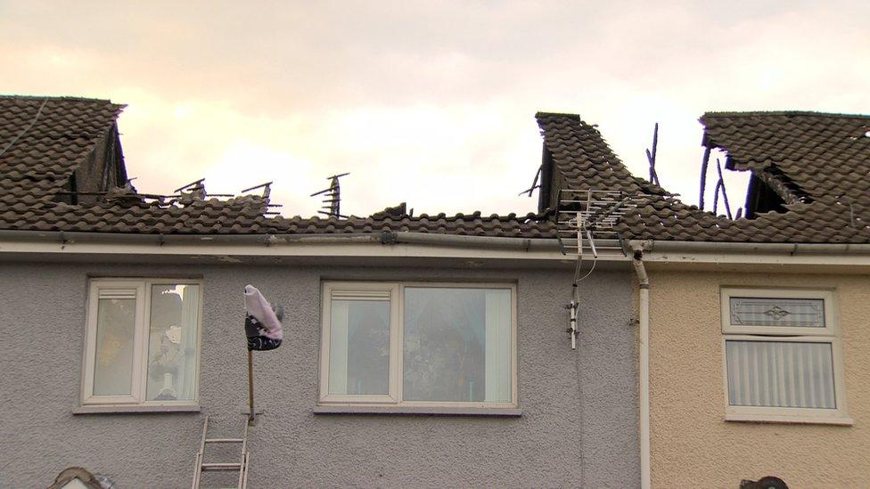 Fire-damaged houses at Hopewell Square in Belfast's Shankill area