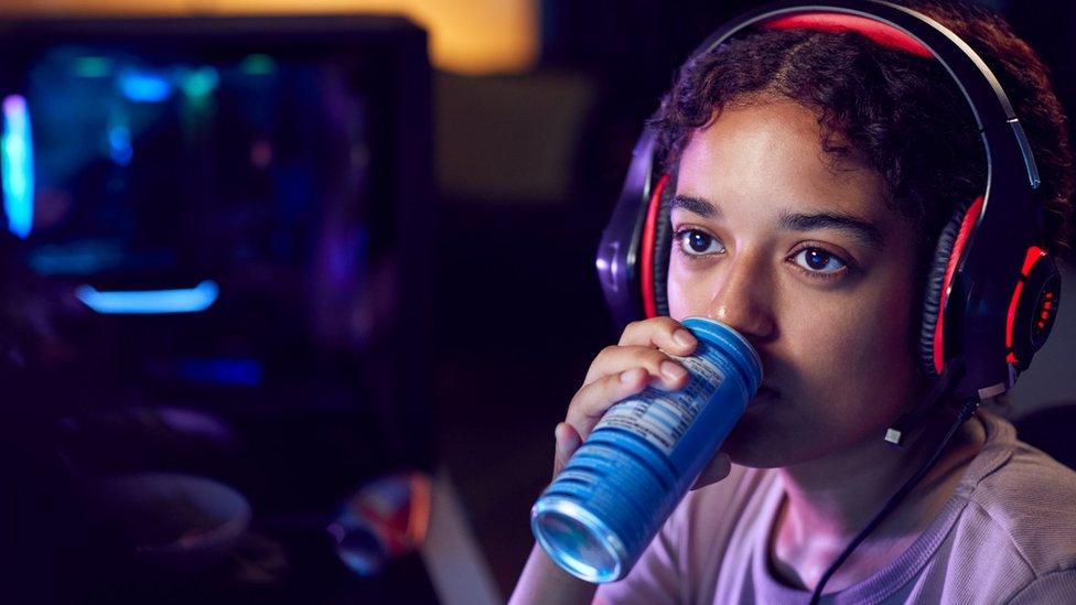 Girl drinking from a can