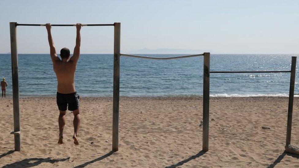 A man exercises on a beach, following the coronavirus disease (COVID-19) outbreak, in Athens, Greece, April 28, 2020