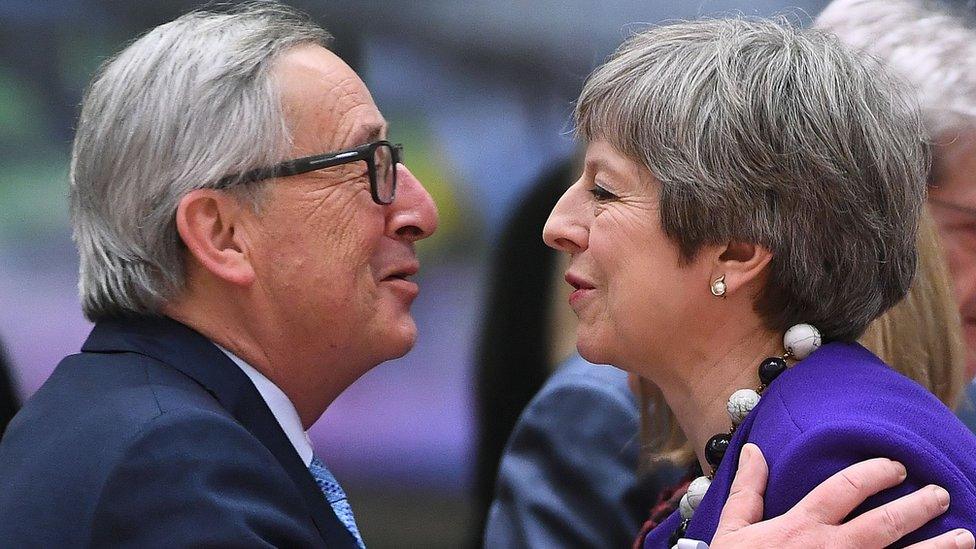 Britain's Prime minister Theresa May greets European Commission President Jean-Claude Juncker (L) as they attend a European leaders summit at the European Council in Brussels on March 22, 2018.