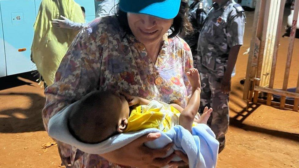 Aid worker with baby