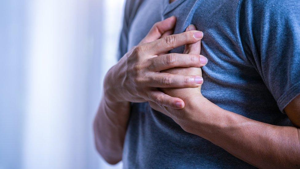 Man with hands on his chest