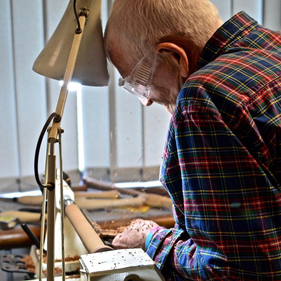 Man turning wood in a Men's Shed