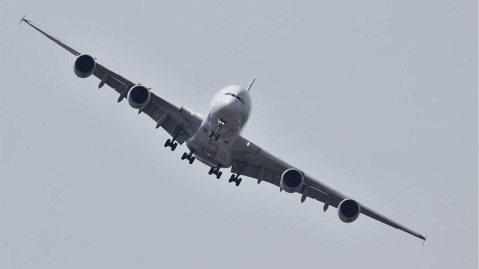 An Airbus A380 flies in a display