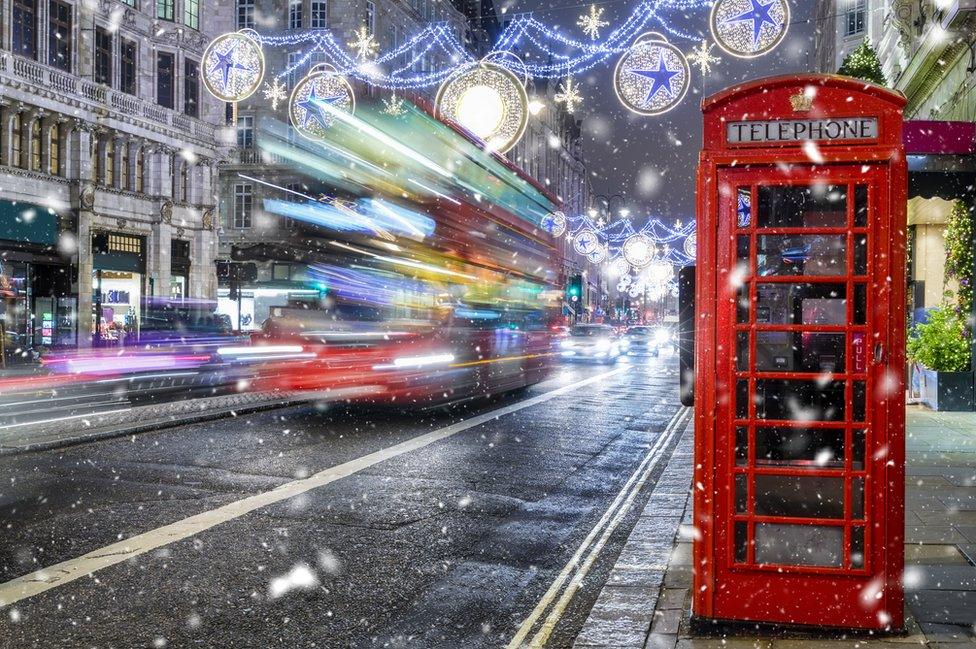 A bus travelling under the Christmas lights in London's West End