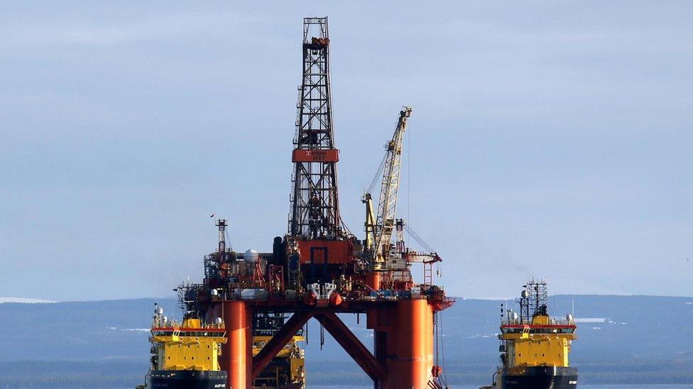 An oil platform is moved by tug boats in the North Sea