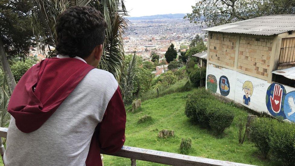 Luis stands on the balcony at Benposta