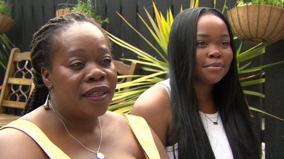 Apolonia and Angel Mbondiya sit in a garden