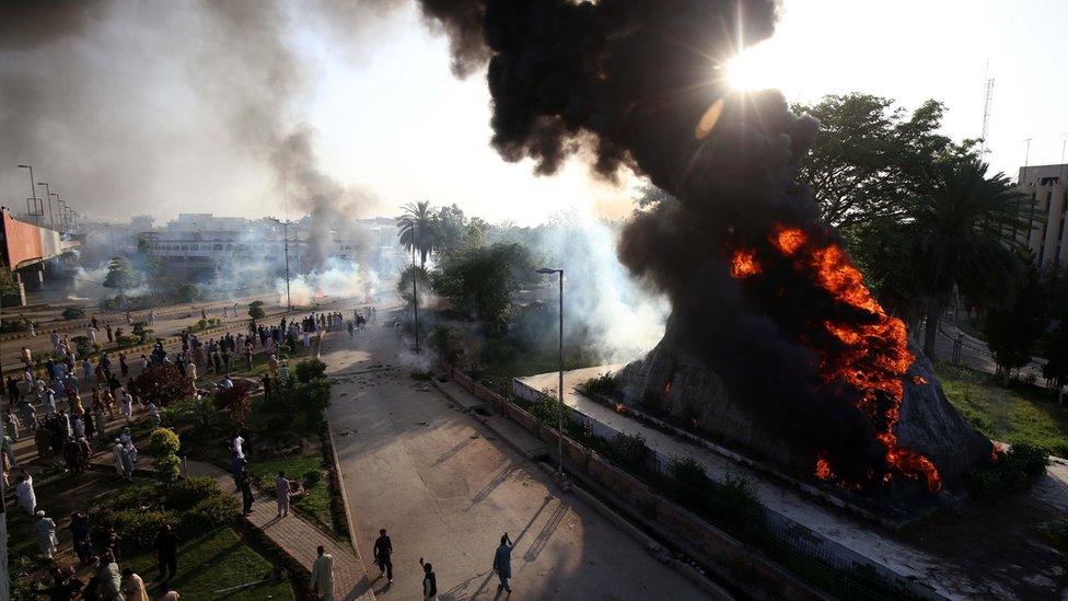 Flames rise from the Radio Pakistan premises after it was set on fire during clashes between police and supporters of Pakistan's former Prime Minister Imran Khan protesting against his arrest, in Peshawar, Pakistan, 09 May 2023.