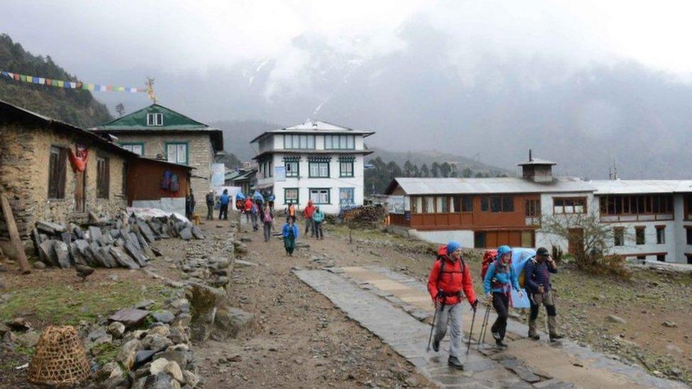 Two climbers set off with their guide towards Everest Base Camp