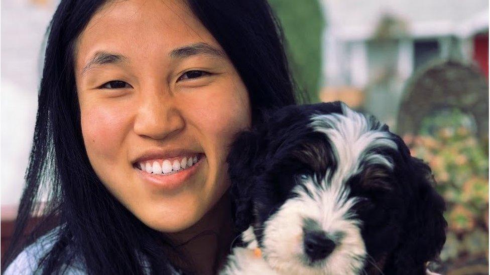 Girl poses with a dog