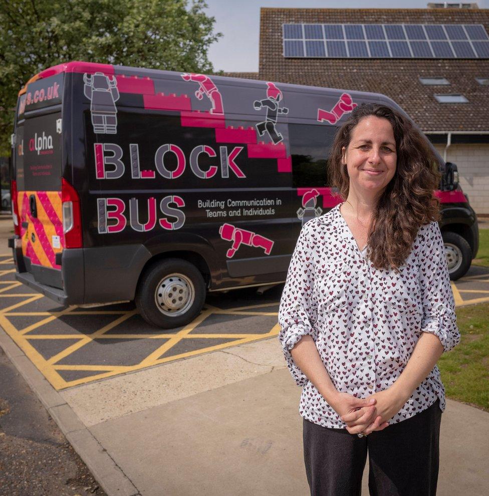 Founder Amy Eleftheriades stands in front of the Alpha Bus