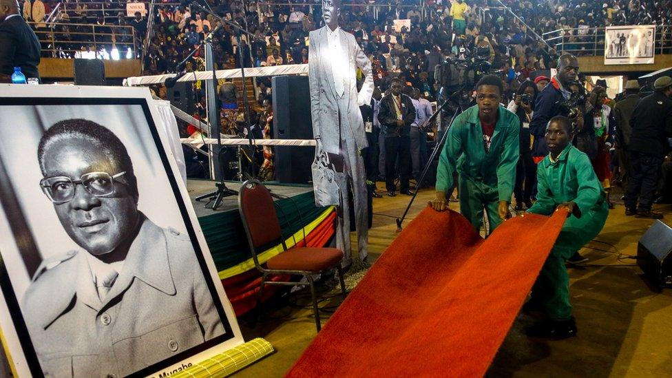 Workers in Zimbabwe prepare a red carpet for a meeting between the president the association of war veterans - Thursday 7 April 2016