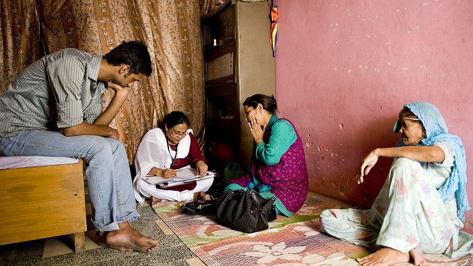 Indian census enumerators Kalpana Singh (2L) and Reena Sharma (2R) takes the details of an Indian Muslim family for the census in New Delhi on May 11, 2010.