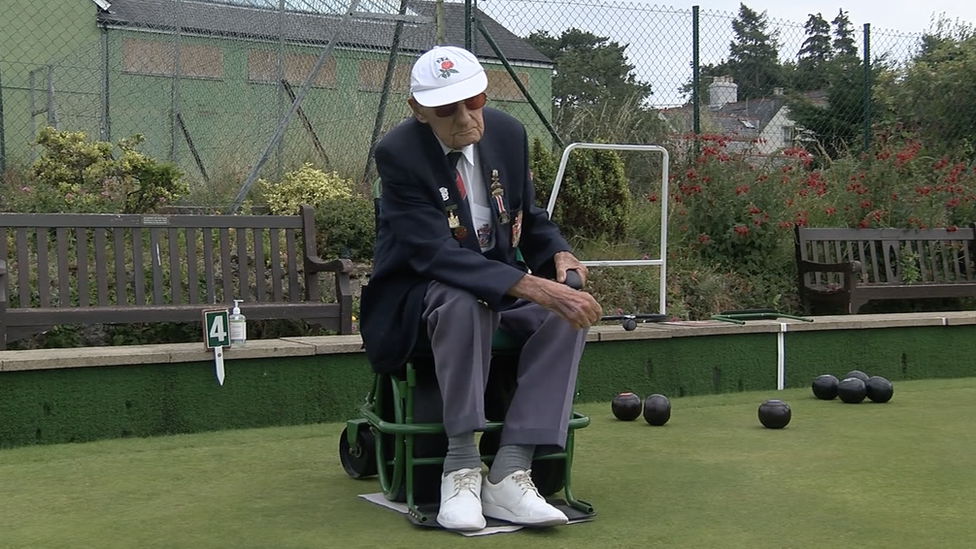 Mr Short bowling from his chair