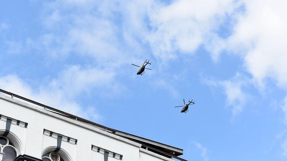 Two police helicopters fly past Southwark Cathedral as the funeral cortege of PC Keith Palmer passes by