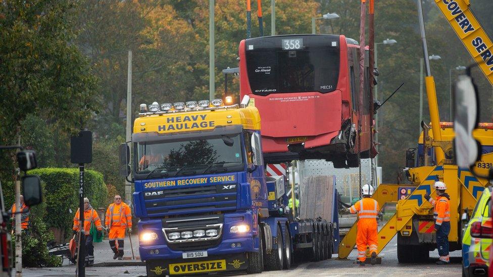 Bus being craned onto recovery truck