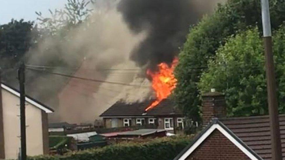 Roof of bungalow on fire