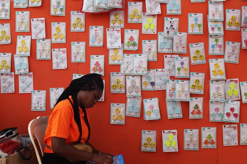 A woman selling children gift toys waits for buyers.