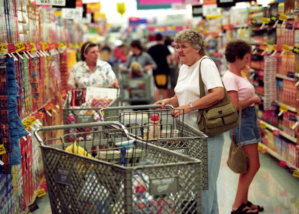 Customers shop during the grand opening of a Wal-Mart Supercenter August 14, 2002 in Athens, Ohio.