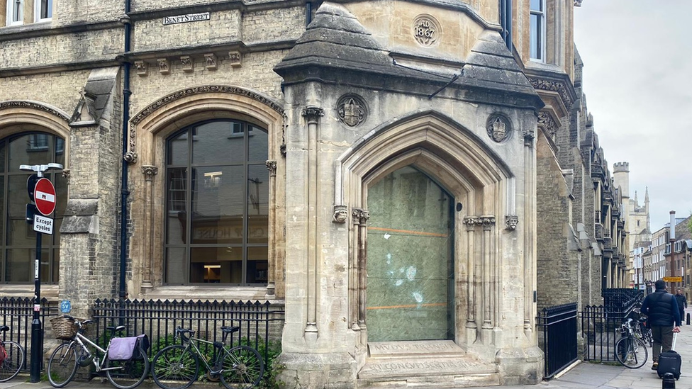 The site of The Corpus Christi Clock, boarded up, in Cambridge