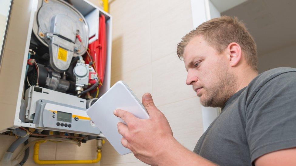 Technician repairing gas boiler