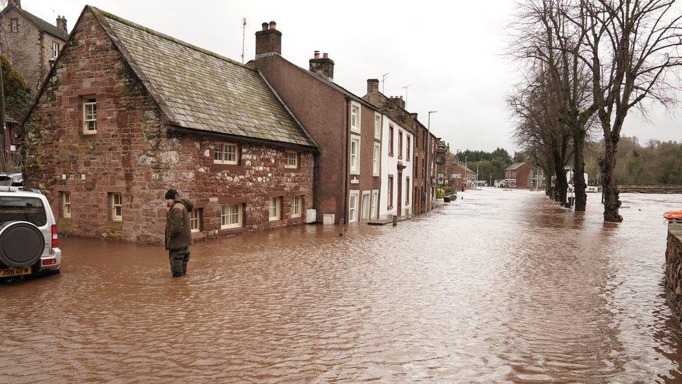 Water in the road outside her home