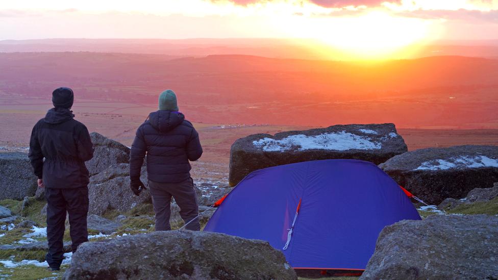 Hikers wild camping on open moorland on Dartmoor