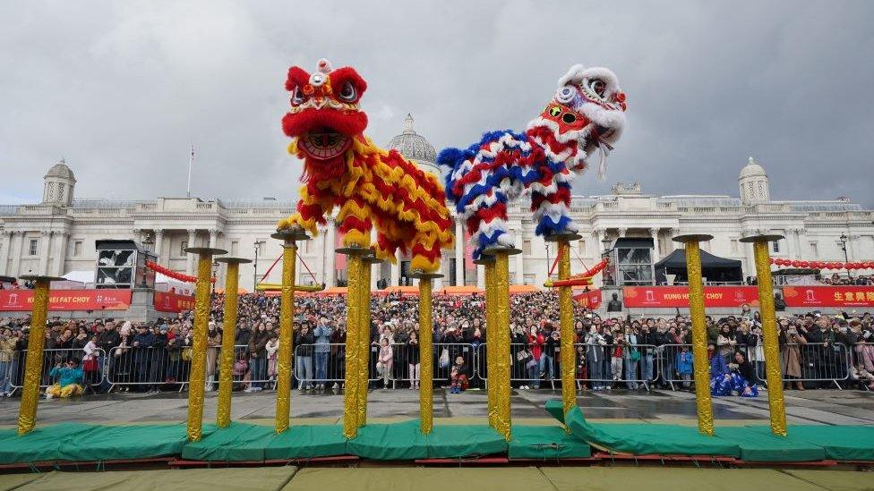 Chinese lion performance on raised poles.