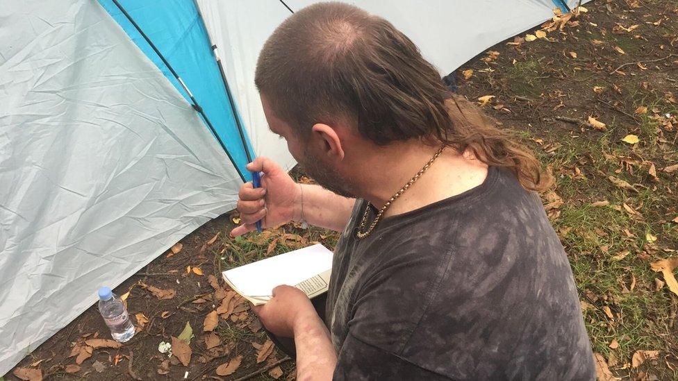 Alan looking at the damage to his tent