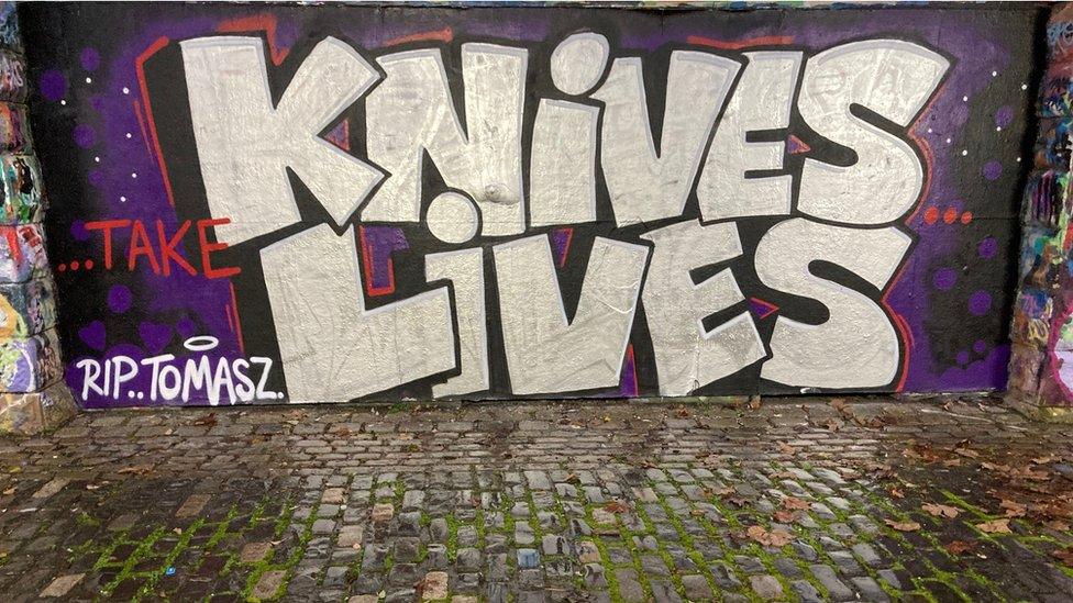 Graffiti artwork saying Knives Take Lives