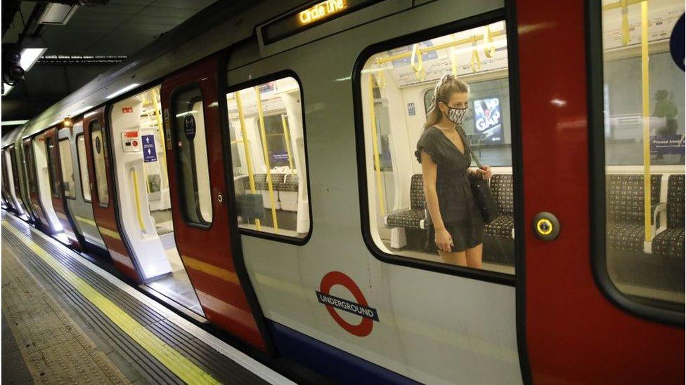 masked woman on train